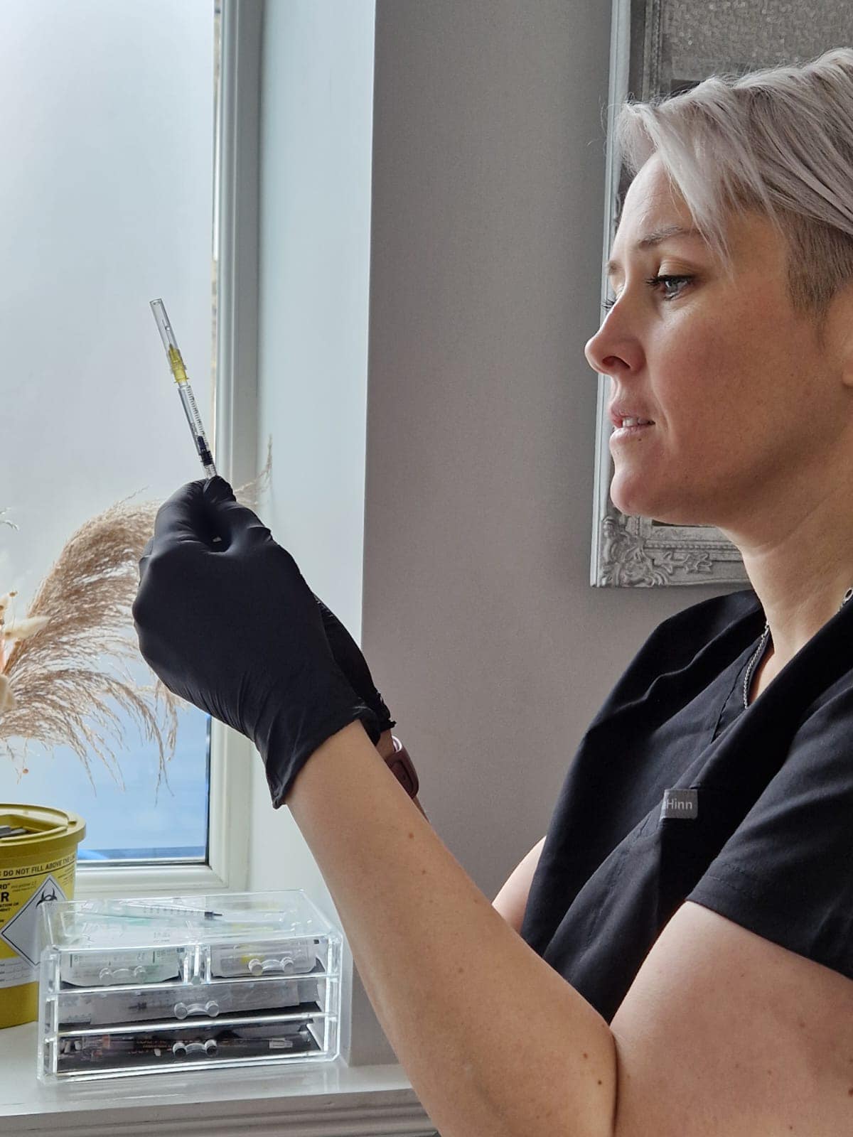 Becky Lambert-Pitts, midwife-trained medical aesthetician, preparing a treatment in her Wilsden clinic